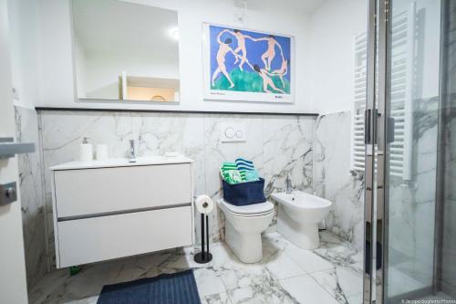 a bathroom with a toilet and a sink at Toffee Gioberti - Seven Suites Sanremo in Sanremo
