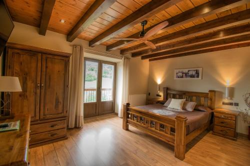 a bedroom with a bed and a wooden ceiling at Casa Rural Aldekoa in Ziga