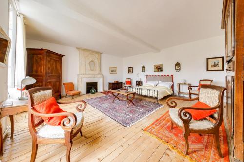 ein großes Wohnzimmer mit einem Bett und einem Kamin in der Unterkunft Maison de 4 chambres avec jardin et wifi a Julienne in Julienne