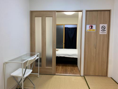 a room with a door leading to a bedroom at EX2 Higashimikuni Hous in Osaka
