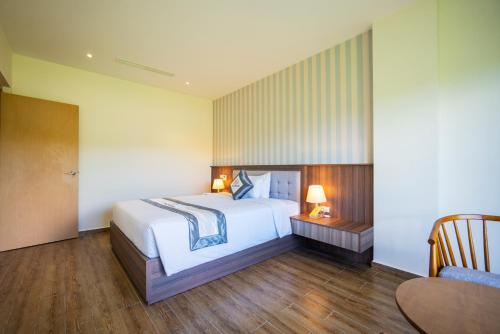 Cama o camas de una habitación en UMI-PQ hotel