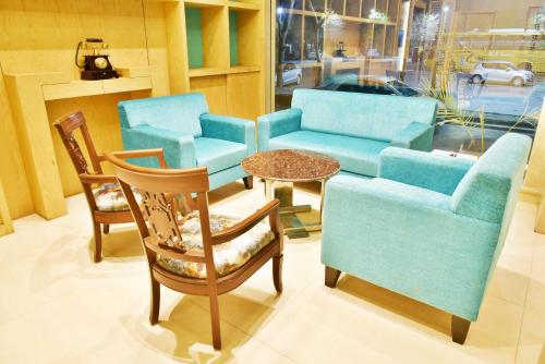 a room with chairs and a couch and a table at Hotel Amritsar International 2 min walk from Amritsar Bus Stand in Amritsar