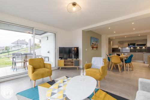 un salon avec une table et des chaises dans l'établissement Appartement IRE, à Sévrier