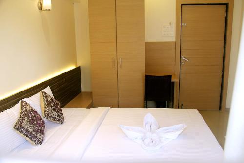 a bedroom with a bed with a flower on it at Hotel SaiPrasad Executive Solapur in Solapur