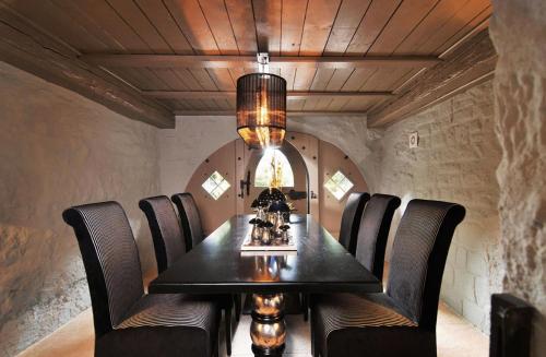 a dining room with a black table and chairs at Hotel Herrnschloesschen in Rothenburg ob der Tauber