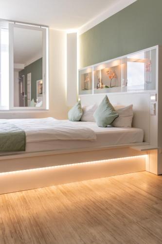 a bedroom with a large bed with lights on it at bedpark Stellingen in Hamburg