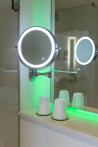 a mirror on a counter in a bathroom at bedpark Stellingen in Hamburg