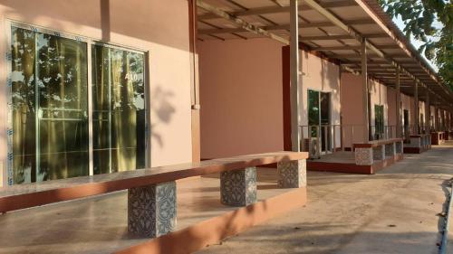 a row of benches on the side of a building at Baan Suan Chiva Saran in Nong Bua Lamphu
