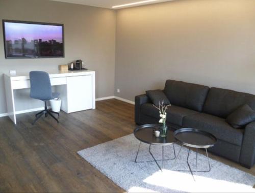 a living room with a couch and a table at wolke 4 in Büren an der Aare