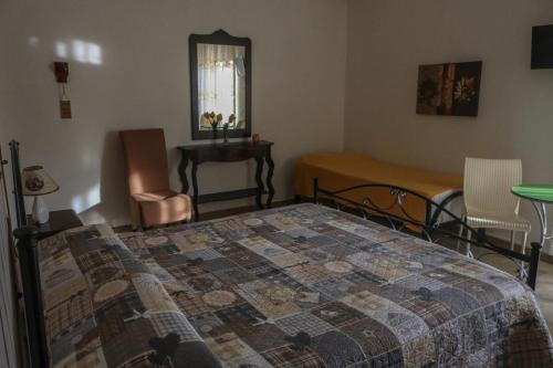 a bedroom with a bed and a table and chairs at Sogno Salento in Guagnano