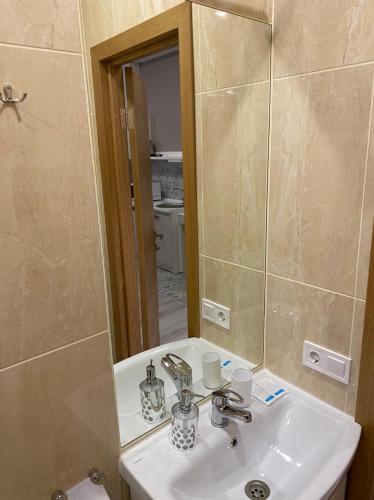 a bathroom with a sink and a mirror at Heart Kyiv Apart-Hotel in Kyiv