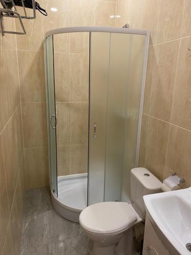 a bathroom with a shower and a toilet and a sink at Heart Kyiv Apart-Hotel in Kyiv