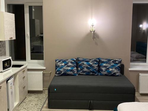 a living room with a couch in a room at Heart Kyiv Apart-Hotel in Kyiv