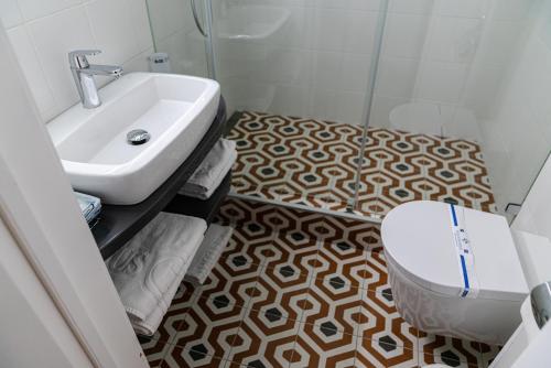 a bathroom with a toilet and a sink at Domus Hotel-1 in Kyiv