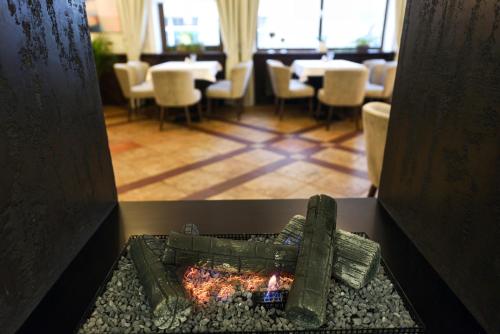 a room with a table and chairs in a restaurant at Zoloto Karpat in Stryi