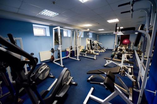 a gym with cardio equipment in a blue room at Zoloto Karpat in Stryi