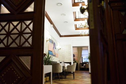 a view of a dining room with a table and chairs at Zoloto Karpat in Stryi