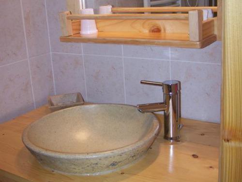 a bathroom with a bowl sink on a counter at Les Grands Champs in Attignat-Oncin