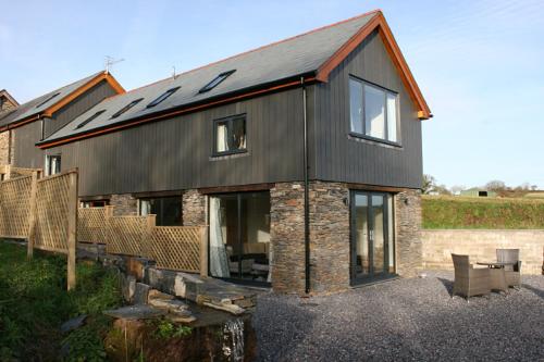 a house with solar panels on top of it at Creber Cottage in Totnes