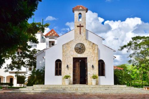 a church with a cross on the front of it at 3BR Apt @CadaquesCaribe Bayahibe in San Rafael del Yuma