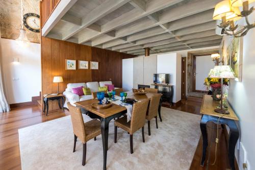 a living room with a table and chairs and a couch at Quinta do Monteverde in Viana do Castelo
