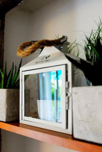 a white microwave sitting on a shelf with a snake on it at Beachfront Apartment Mala Tereza in Split