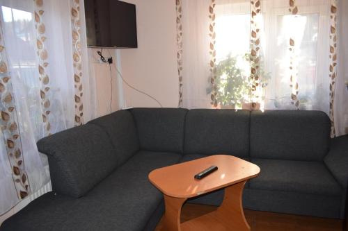 a living room with a couch and a coffee table at Casa Emilia in Vatra Dornei