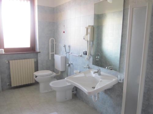 a bathroom with a toilet and a sink at Al Casale B&B in Cherasco