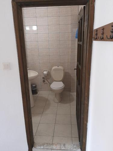 a bathroom with a toilet and a sink at Sığacık Antik Otel in Siğacık