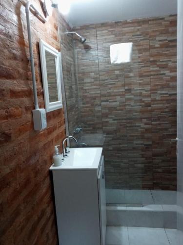 a bathroom with a sink and a shower at Duplex Chacabuco in San Fernando del Valle de Catamarca