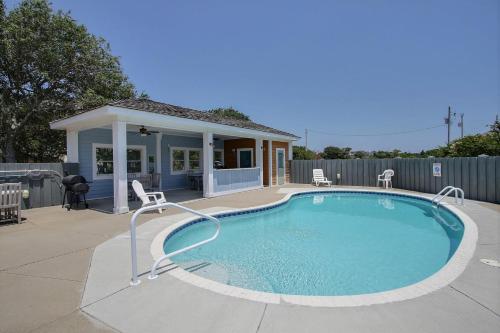 a swimming pool with chairs and a house at The Love Boat #15SV-F in Frisco