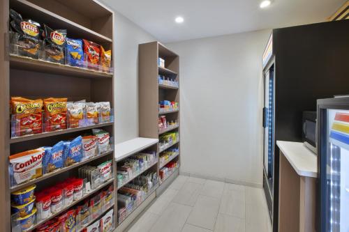 a walk in pantry with shelves filled with food at Holiday Inn Express Rochester-Victor by IHG in Victor