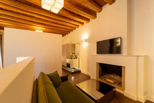 a living room with a couch and a fireplace at Hotel Villa Soligo - Small Luxury Hotels of the World in Farra di Soligo
