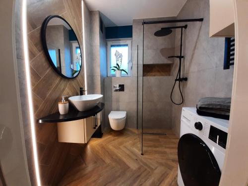 W łazience znajduje się umywalka i lustro. w obiekcie MARINA Jantar w mieście Jantar