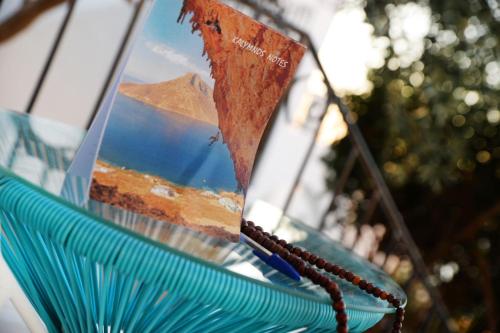 a reflection of a mountain in a window with a rosary at Calma apartment in Masouri