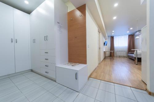 a room with white cabinets and a room with a table at FlatRent SmartHouse in Kyiv