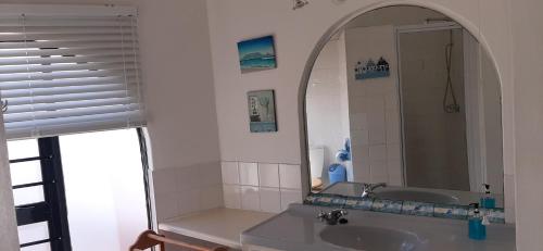 a bathroom with a sink and a mirror at Oom Piet Accommodation in Gansbaai