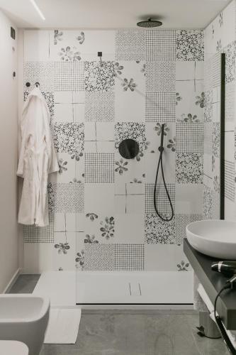 a bathroom with a toilet and a sink and a shower at WeLive in Carpi