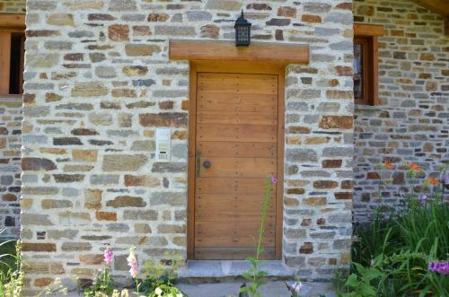 a wooden door on the side of a stone building at Chalet Lè Lodzé - Pieds des pistes in La Rosière