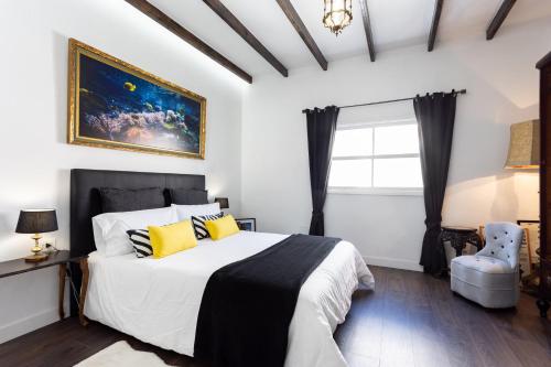 a bedroom with a large bed with yellow pillows at Home2Book El Faro de La Laguna, terrace & wifi in Las Lagunas