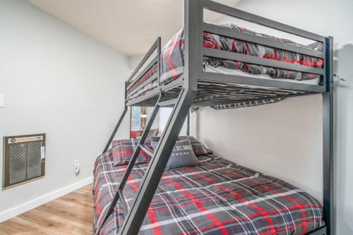 a bunk bed in a attic room with a staircase at Skyleaf in Sugar Mountain
