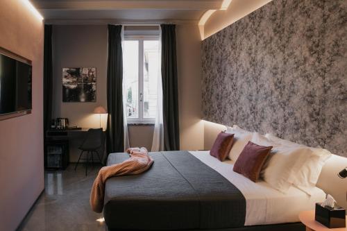 a bedroom with a large bed and a window at WeLive in Carpi