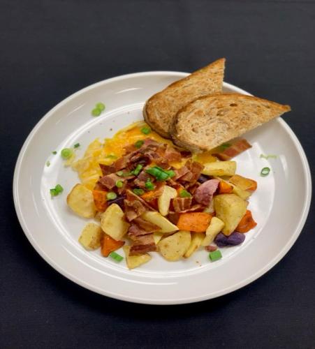 a white plate of food with eggs potatoes and toast at EVEN Hotel Chicago - Tinley Park - Convention Center by IHG in Tinley Park