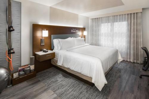 a hotel room with a large bed and a window at EVEN Hotel Chicago - Tinley Park - Convention Center by IHG in Tinley Park