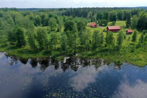 an aerial view of a house next to a lake at Holiday home Småland Gäddegölshult in Gäddegölshult