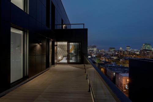 a balcony of a building with a view of the city at Hotel St.Thomas in Montreal