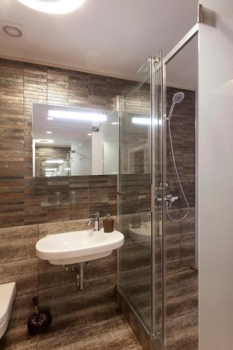 a bathroom with a sink and a shower at Piu Trendy Rooms in Zagreb