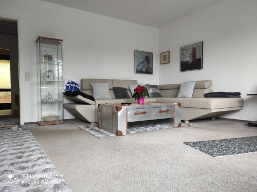 a living room with a couch and a table at Waldhus in Ueckeritz