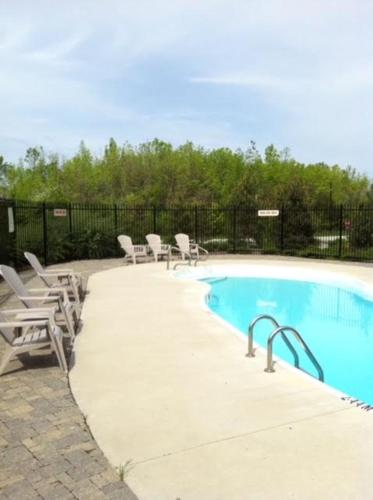 a swimming pool with lounge chairs at Blue Mountain-Luxurious BlueSki George Chalet, Hot Tub, Pool, Gas Fireplace in Blue Mountains