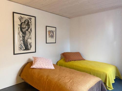 a room with two beds and a painting on the wall at Gästehaus am Lagerplatz in Winterthur